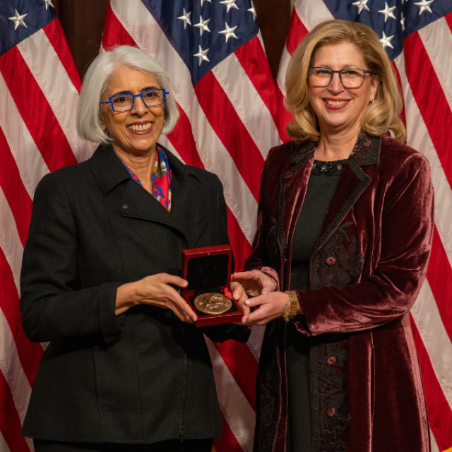 Dr. Teresa K. Woodruff accepting National Medal of Science from Dr. Arati Prabhakar.