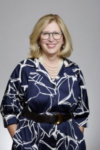 Photo of Dr. Teresa Woodruff smiling in a blue and white dress.